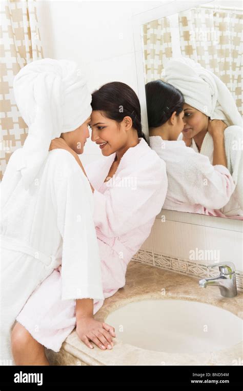 Romantic lesbian couple taking bath together and relaxing.